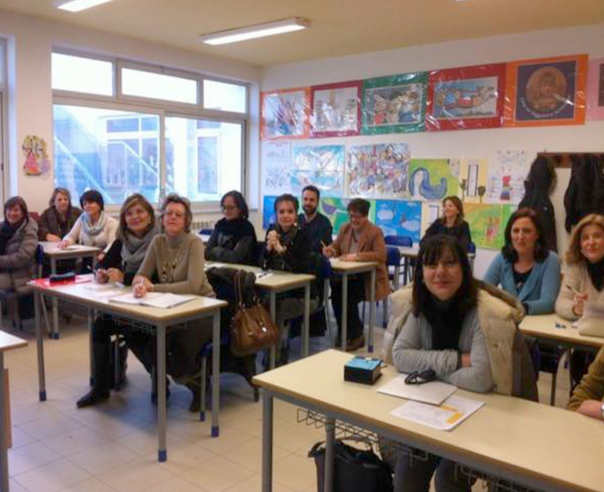 Acerra, Naples province, Teachers among the desks. Students climb into the chair.